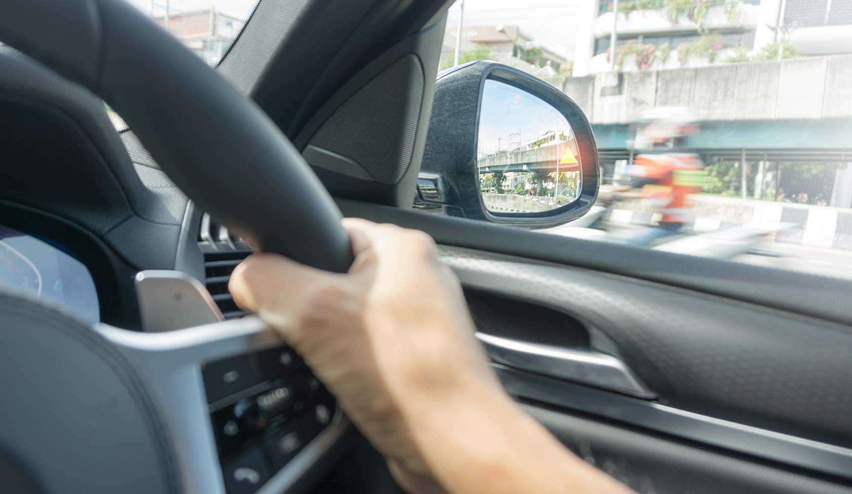 Car side mirror used to check blind spot before changing lanes safely