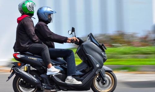 Two individuals on a motorcycle illustrating important safety tips for pillion riders in Singapore